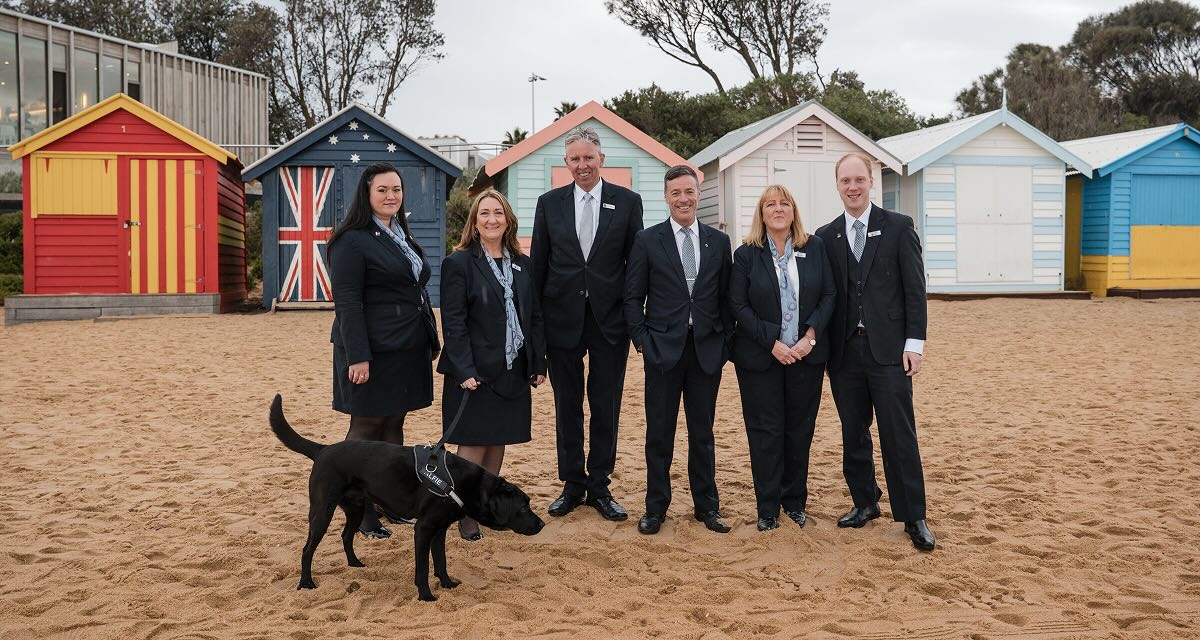 funeral directors on beach with dog